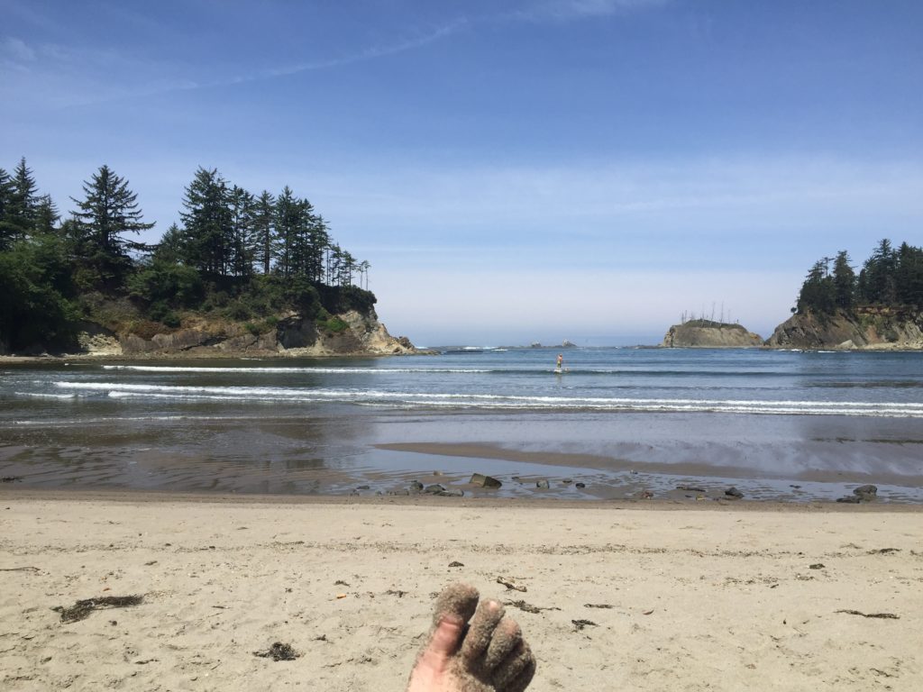 a "rest day" at sunset bay, oregon (we still biked 20 miles). note the stand up paddleboarder. 